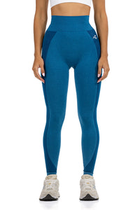 Seamless Ribbed Yoga Leggings in Petrol Blue, front view on model showing the high ribbed waistband, Ascendia