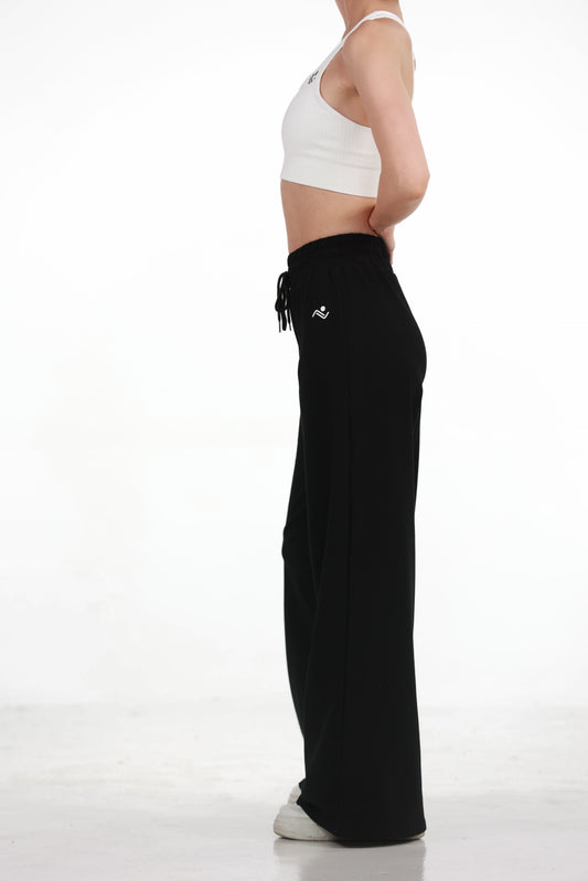 Low Fit Cotton Yoga Pants in Black, full-length front view showing the drawcord waist and wide leg, Ascendia