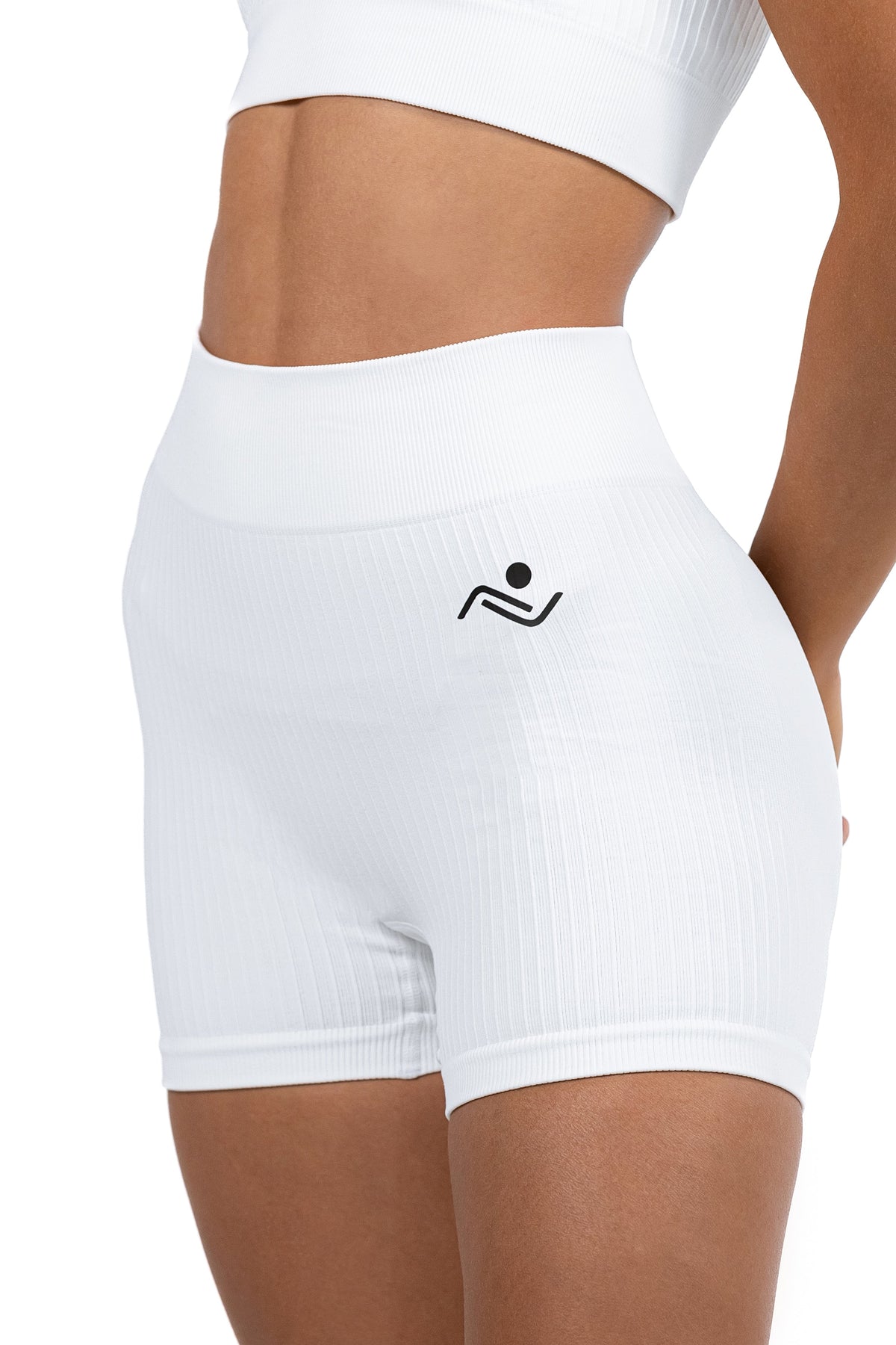 Shape Sculpt Fitness Shorts in White, three-quarter front view showing the ribbed leg, Ascendia