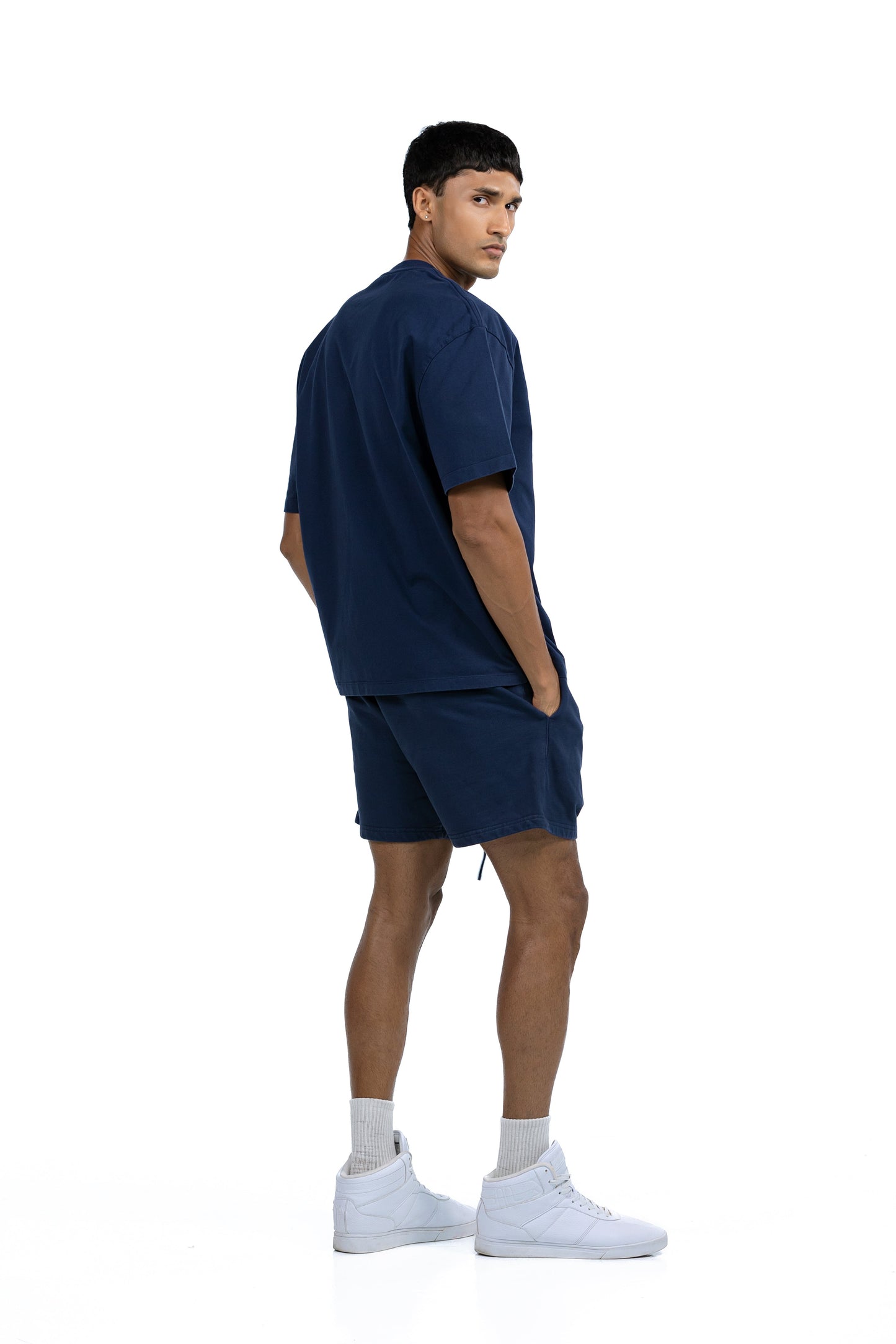 Workout Tee & Short Set in Navy, three-quarter back view on male model looking over his shoulder, Ascendia
