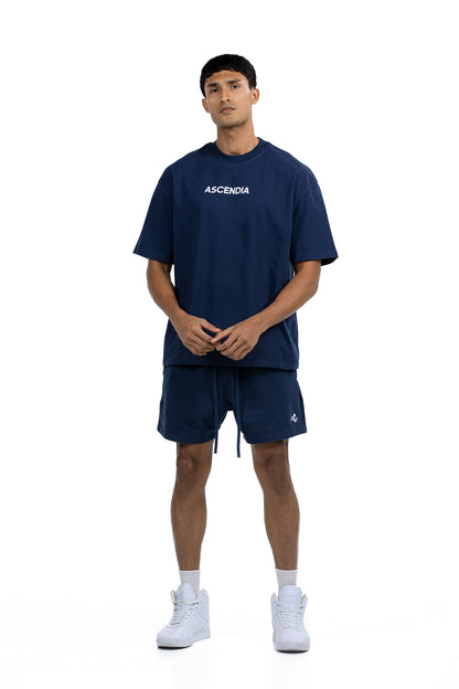 Workout Tee & Short Set in Navy, front view on male model with hands clasped at the waist, Ascendia