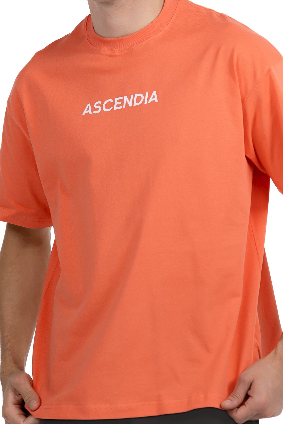 Comfort Oversized T-Shirt in Coral, detail of the chest wordmark on model, Ascendia
