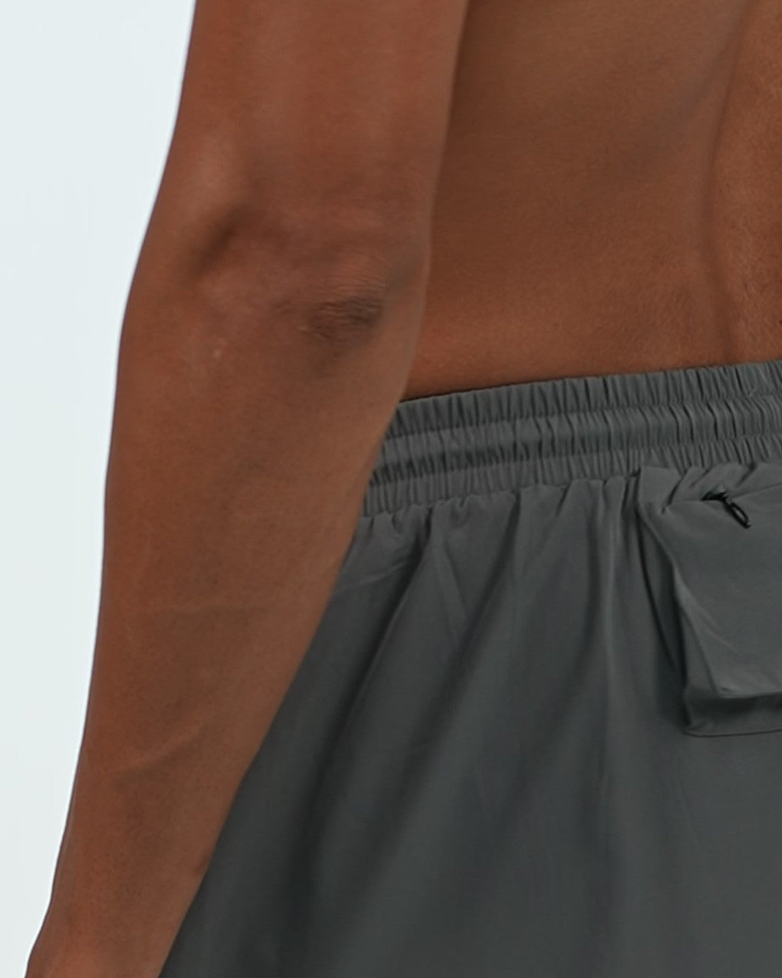 Zip Pocket Training Shorts in Charcoal, back zip pocket detail on model, Ascendia