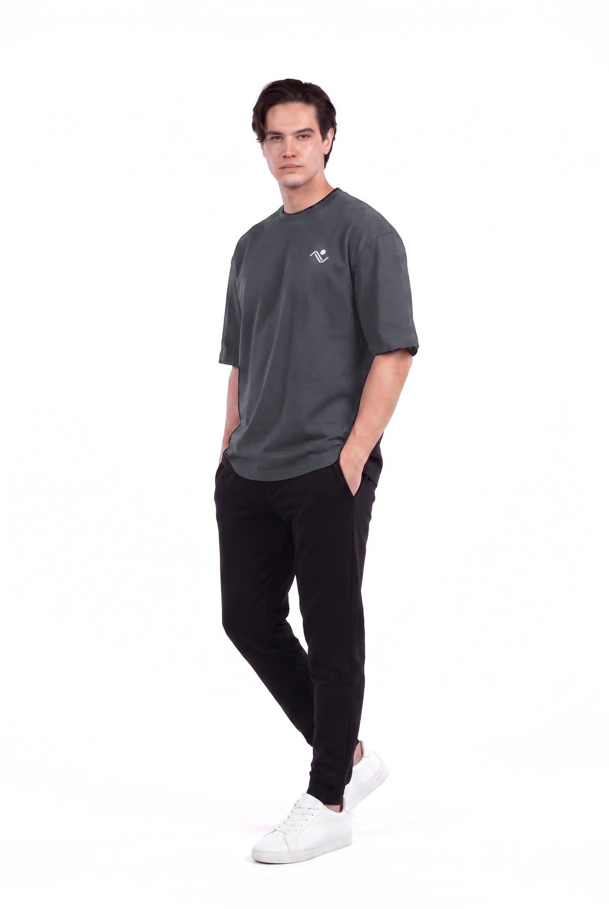 Men's Oversized Cotton Gym T-Shirt in Charcoal, three-quarter front view with hands in pockets, on male model, Ascendia