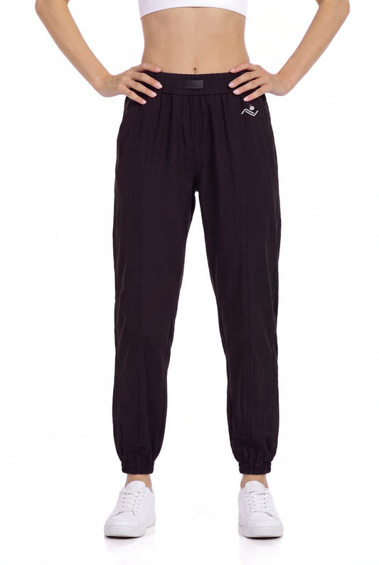 Women's Casual Joggers in Black, front view on model showing the elastic waist and cuffed ankles, Ascendia