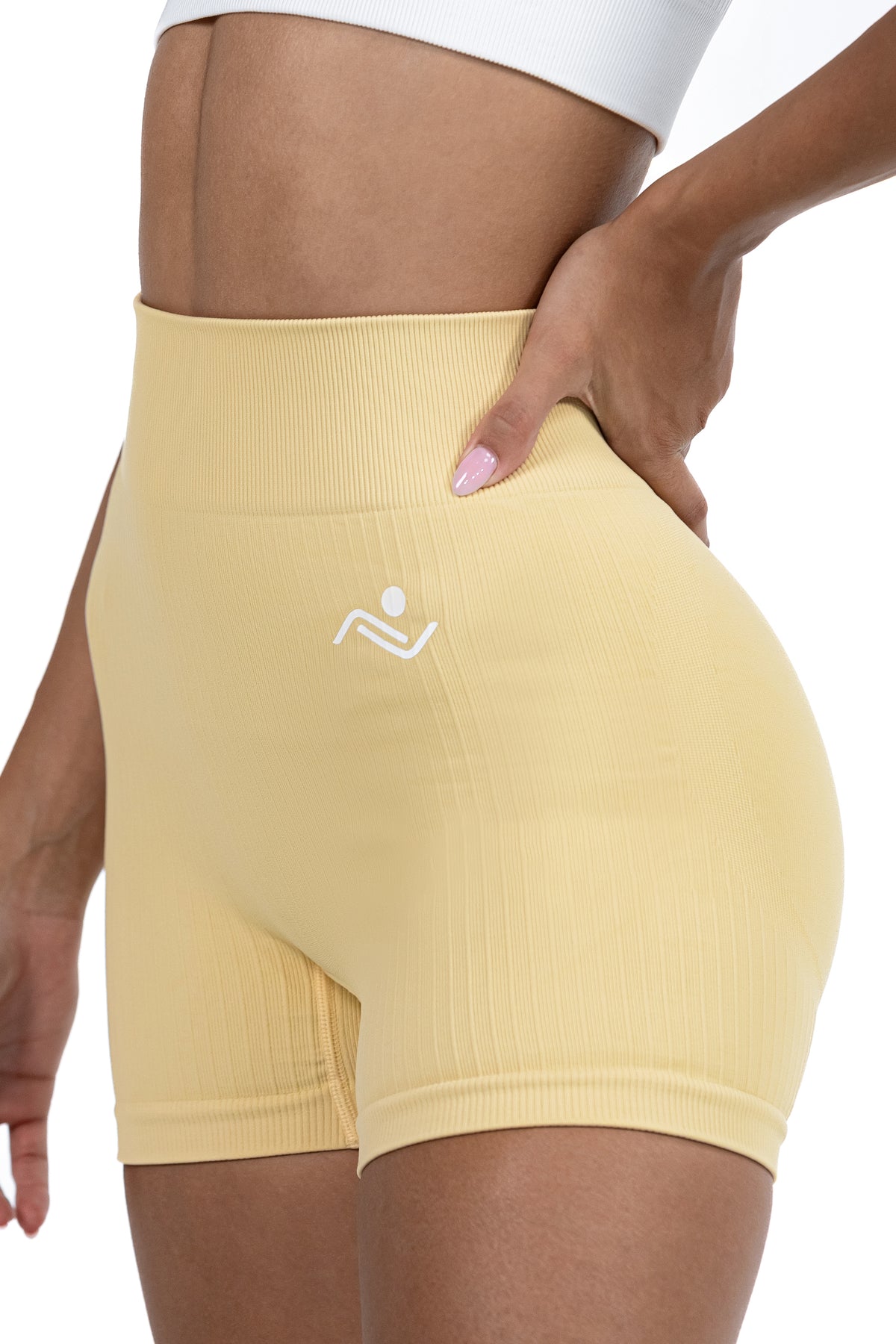 Shape Sculpt Fitness Shorts in Beige, three-quarter front view showing the ribbed leg, Ascendia