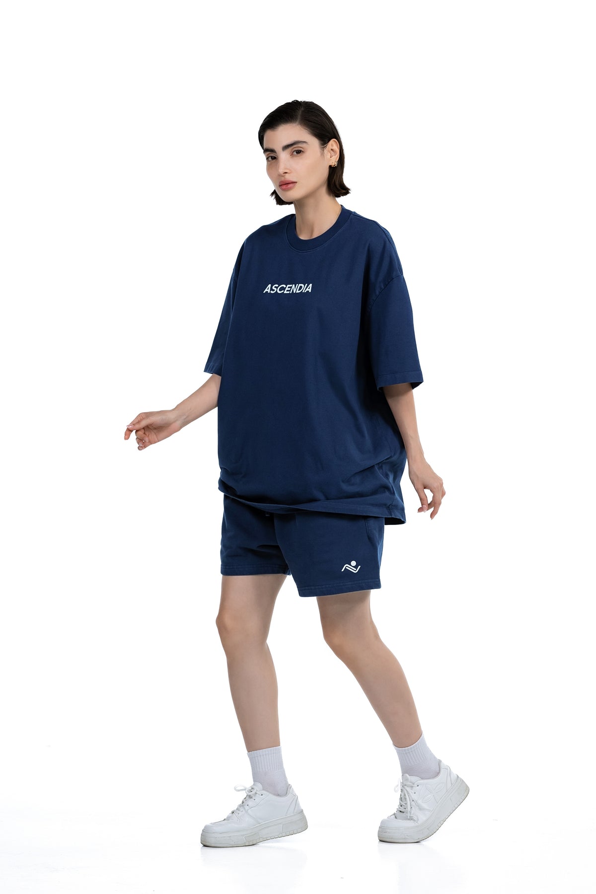 Workout Tee & Short Set in Navy, three-quarter front view on female model walking, Ascendia