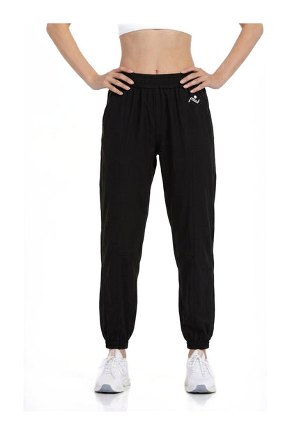 Women's Casual Joggers in Black, front view on model showing the elastic waist and cuffed ankles, Ascendia