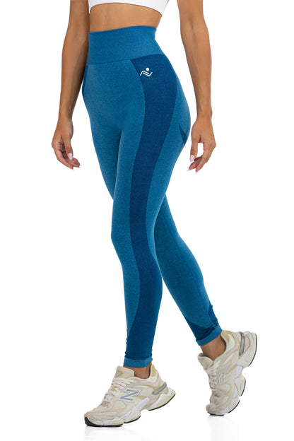 Seamless Ribbed Yoga Leggings in Petrol Blue, three-quarter view showing the hip logo and panel seams, Ascendia